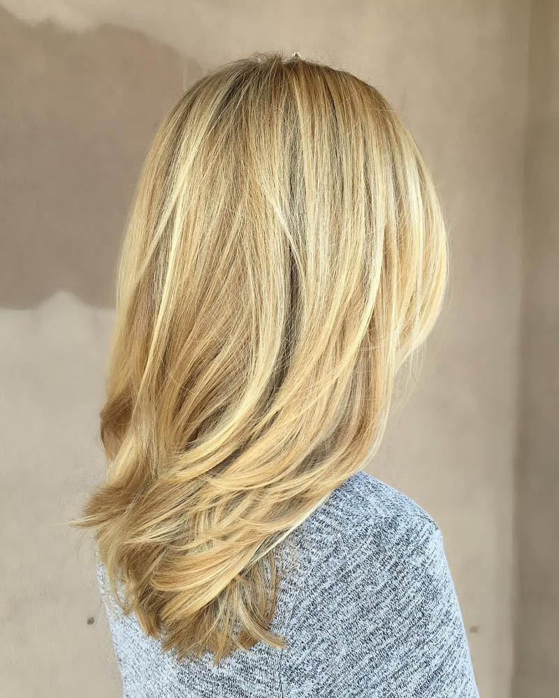 medium length hairstyles women medium blonde hairstyle with v cut layers Luxe Digital