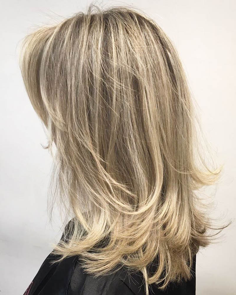 medium length hairstyles women one length medium cut with feathered layers Luxe Digital
