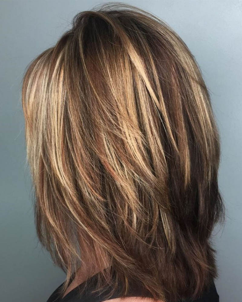 medium length hairstyles women one length medium cut with feathered layers Luxe Digital