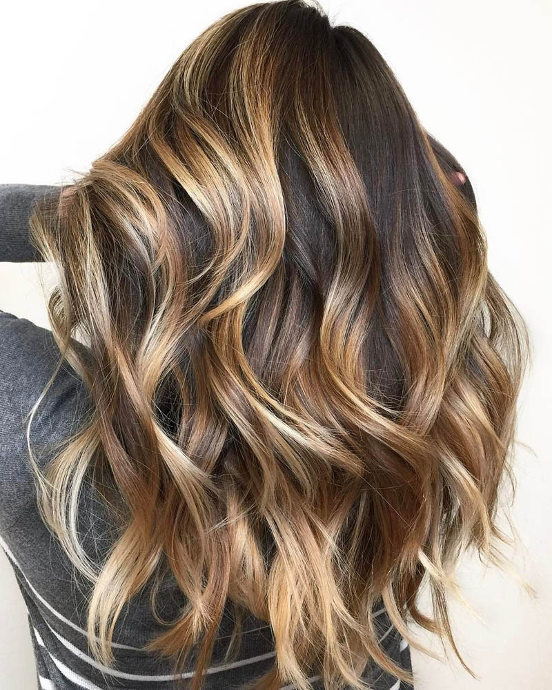 medium length hairstyles women wavy layered hairstyle for dimensional balayage Luxe Digital